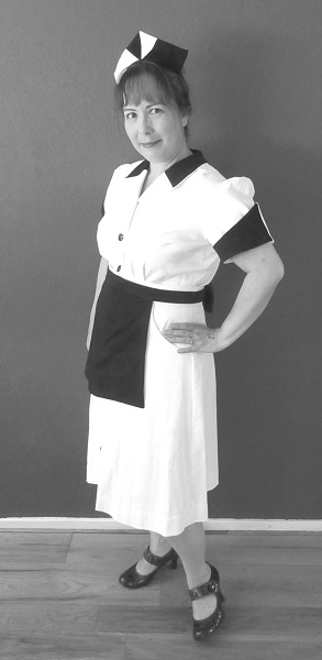 1950s Reproduction Candy Uniform Dress Left Quarter View. Black and white