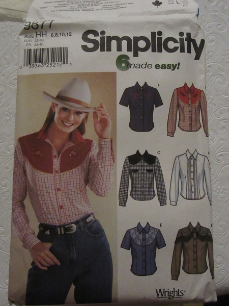 Simplicity 9877 Women's shirt patterns printed in 2001./>
I wanted a button down holiday shirt that I could wear to work. I looked through my pattern stash and the closest thing to a button down work shirt was Simplicity 9877 printed in 2001. Buttons up front and has darts in back and front. Has sleeves with cuffs. No princess seams or darts.
</p>
<p>
Size was 12 and I probably need a 14 or 16, so I widened it to make it more of a size 14, shorted the sleeves an inch, and lengthened the hem by an inch. I made the cuff two pieces instead of folding. I didn't bother with separating the collar into two separate collars, but should have.
</p>
<p>
<img align=